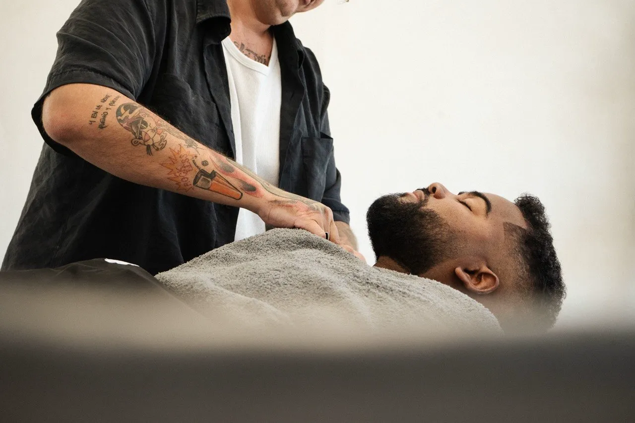 A traditional hot towel shave in progress at Harrisons