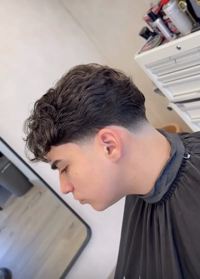 Curly textured crop with a clean low fade, cut at Harrisons